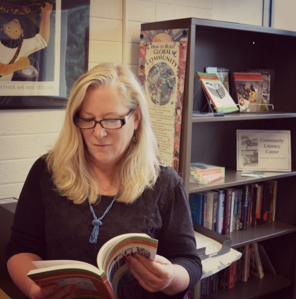 Mary Ellen reading book in office