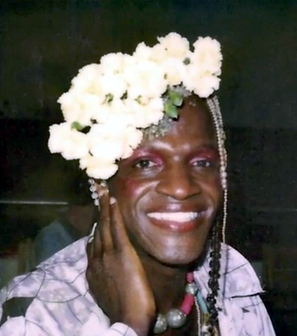 Marsha P. Johnson, smiling with flowers in her hair