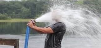 water hose spraying person's face