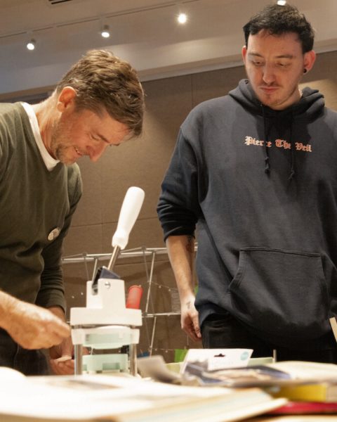 Faculty member and student work together to make buttons at the English Studies Possibilities Fair