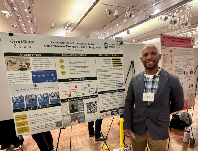 GradShow_web7 Jhon Cortes Lugo standing beside research poster about VR and language learning at Graduate Student Showcase, Nov. 19.