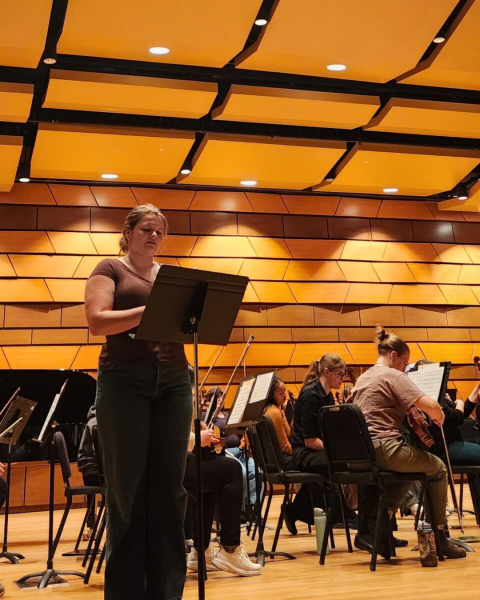 Student reads a poem at CSU music event featuring student poetry. 