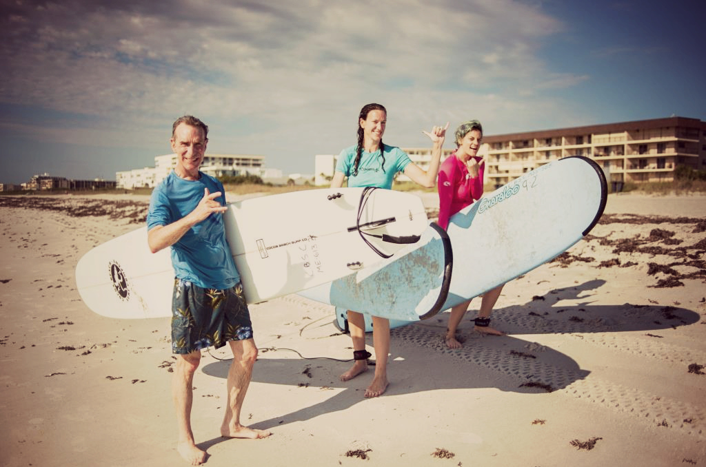 Whitney (on the far right) surfing with Bill Nye, Chief Executive Officer of The Planetary Society