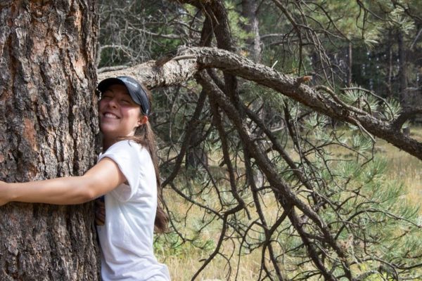 Brooke hugging a tree
