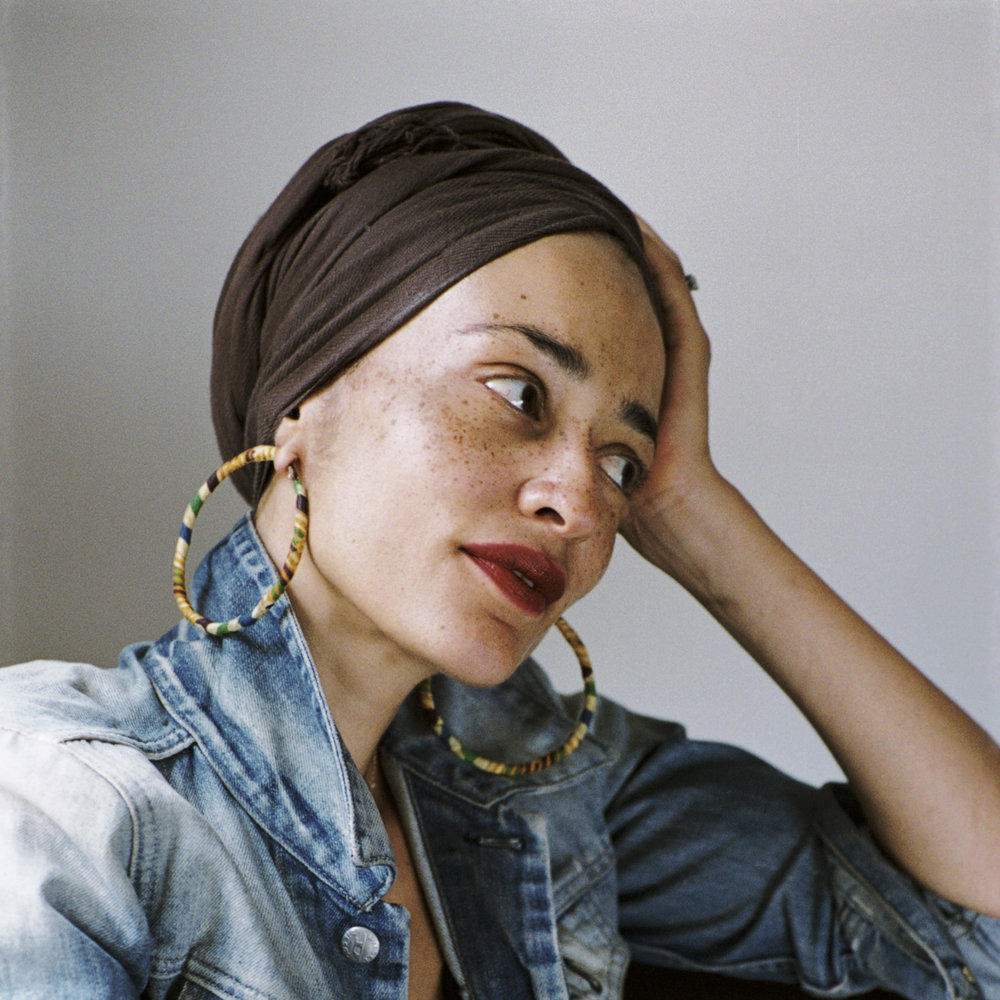 Zadie Smith looking to the side, resting her head in her hand