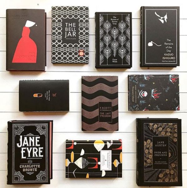 A display of books with a black and red aesthetic including The Handmaid's Tale, The Bell Jar, Jane Eyre, and Jane Austen. 