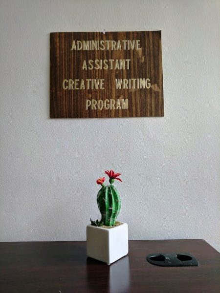 Administrative Assistant Creative Writing Program sign with cactus on table