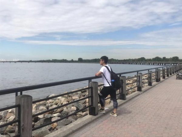 Leon Chen standing next to a body of water