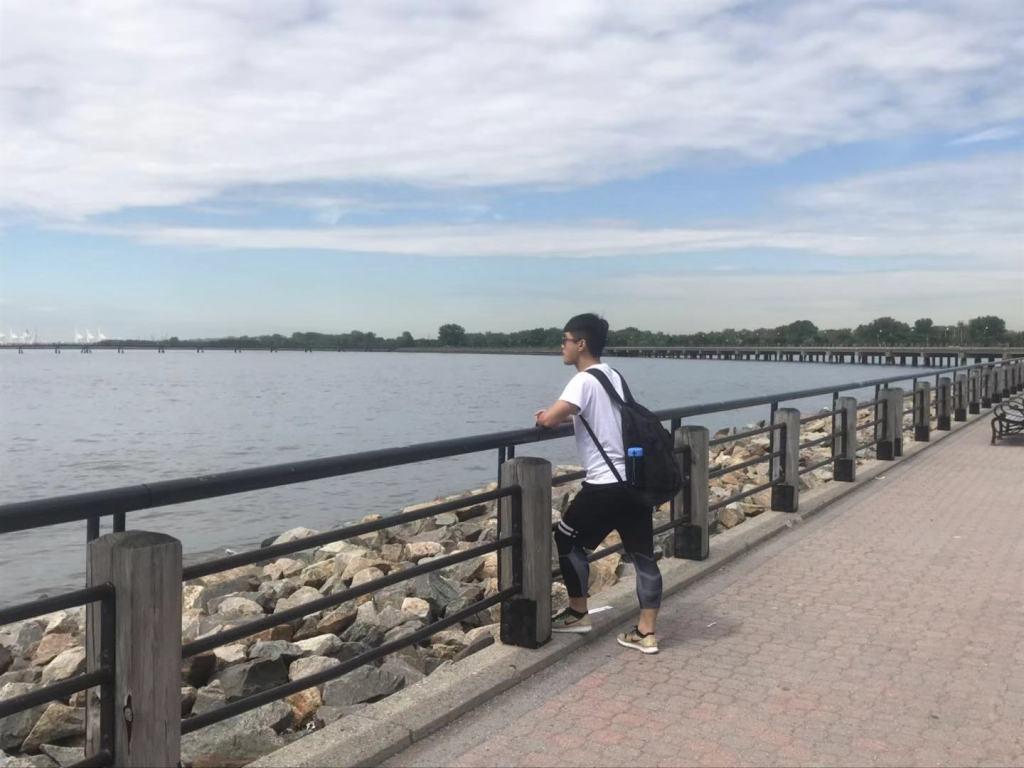 Leon Chen standing next to a body of water