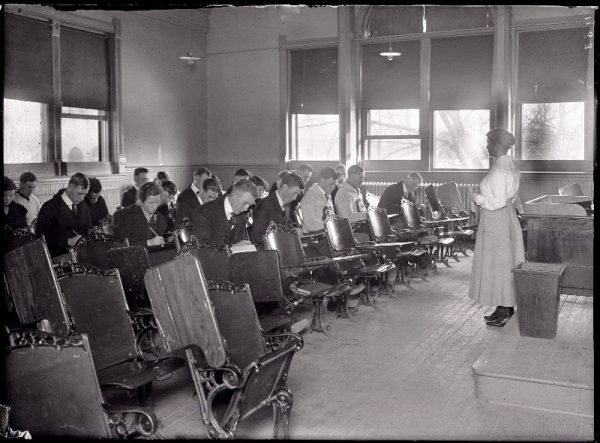 Historical photo of classroom teacher and students