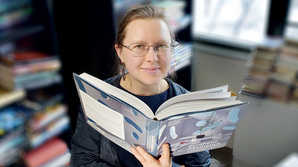 Erika Szymanski behind book