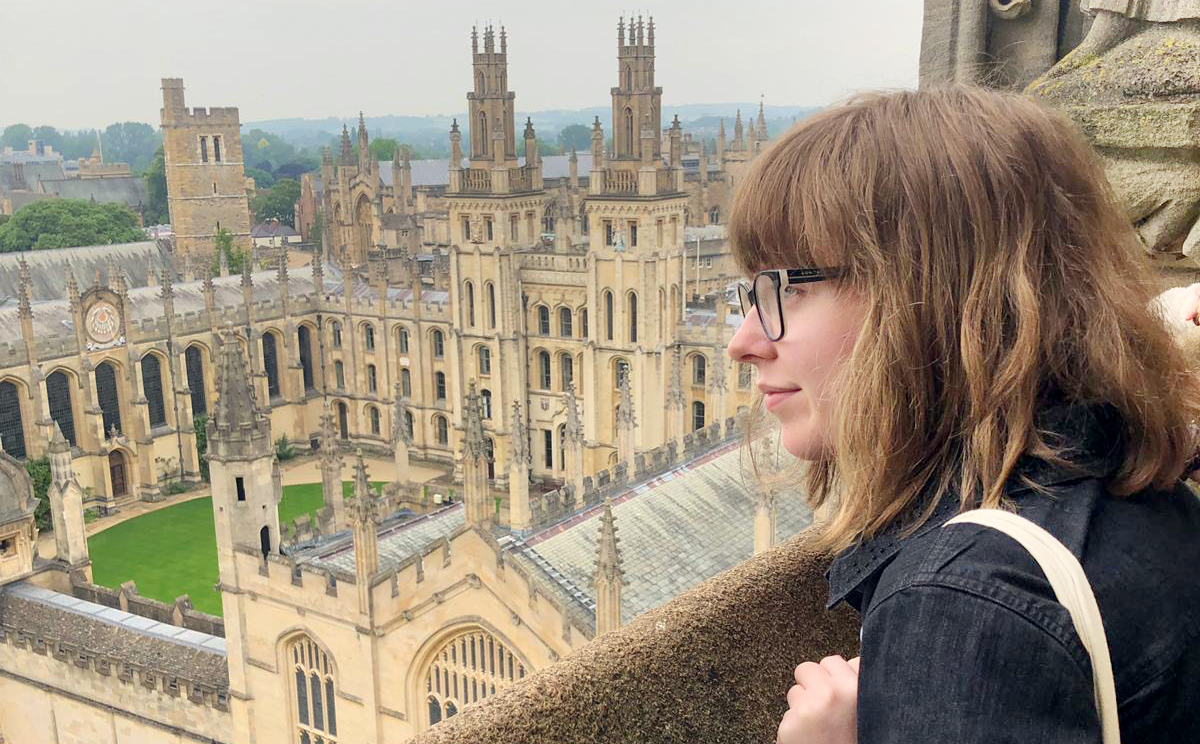Natalia Sperry looking over balcony at Oxford University