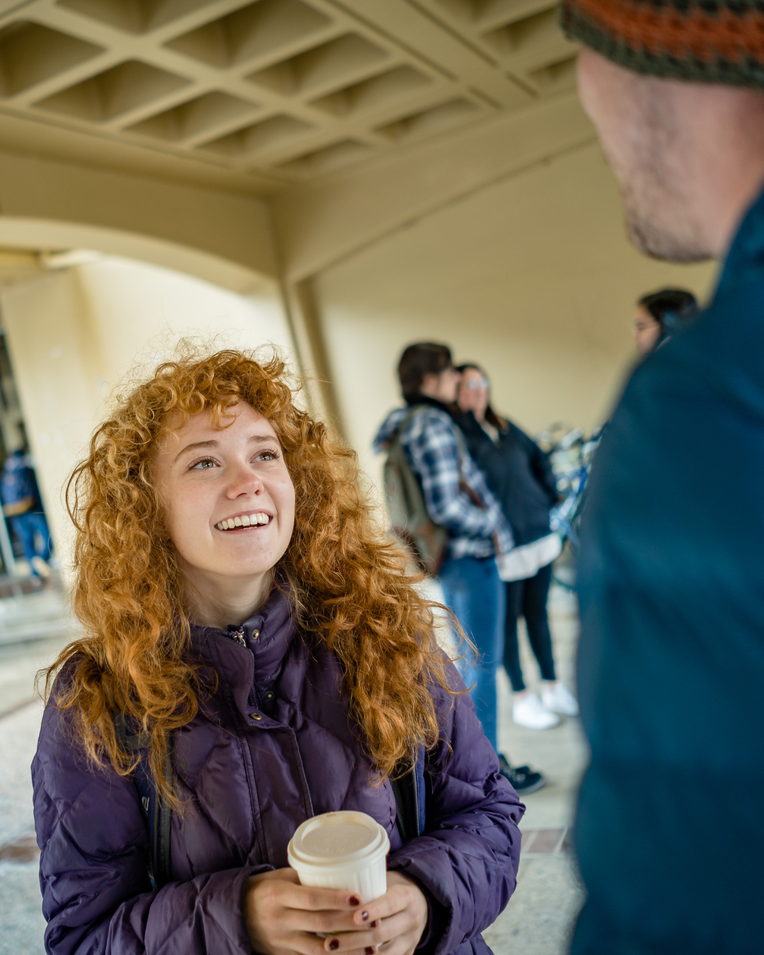 Students talking during a winter day outside Eddy Hall.
