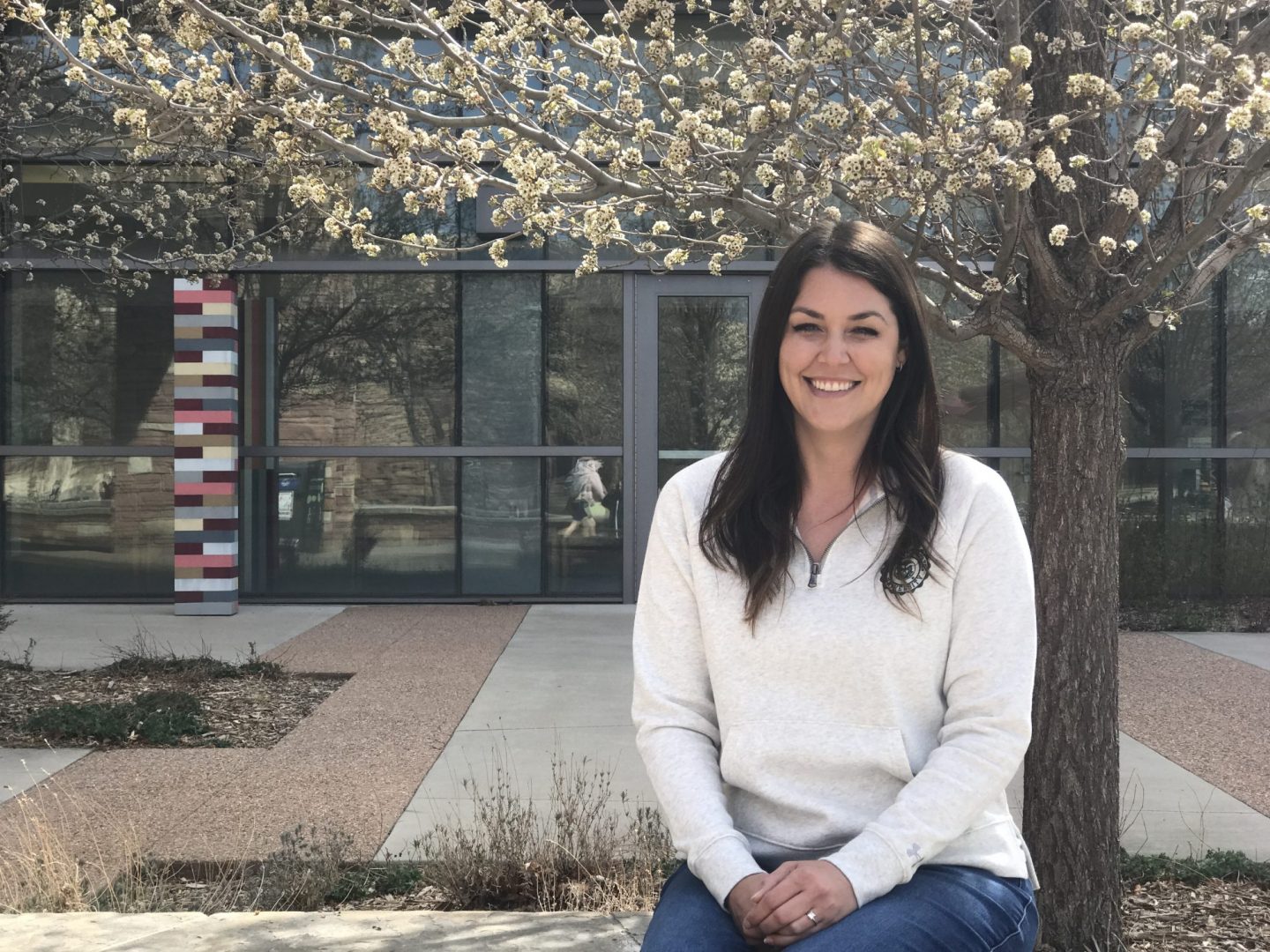 Aly Welker sitting on an outdoor bench on the CSU campus