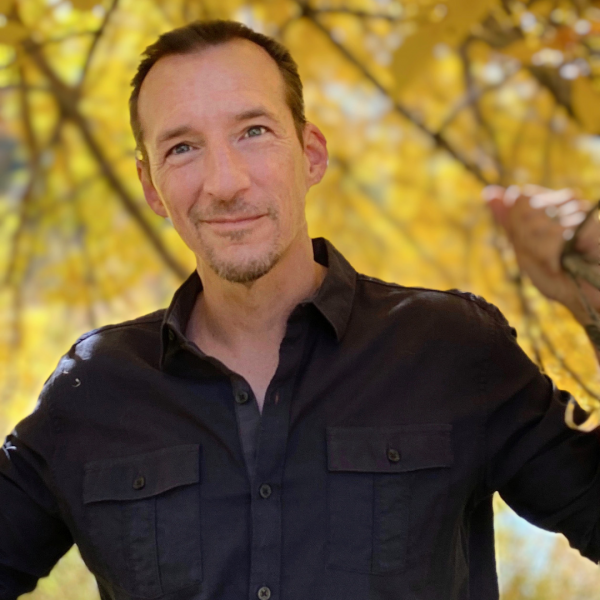 Todd Mitchell headshot with autumn backdrop.