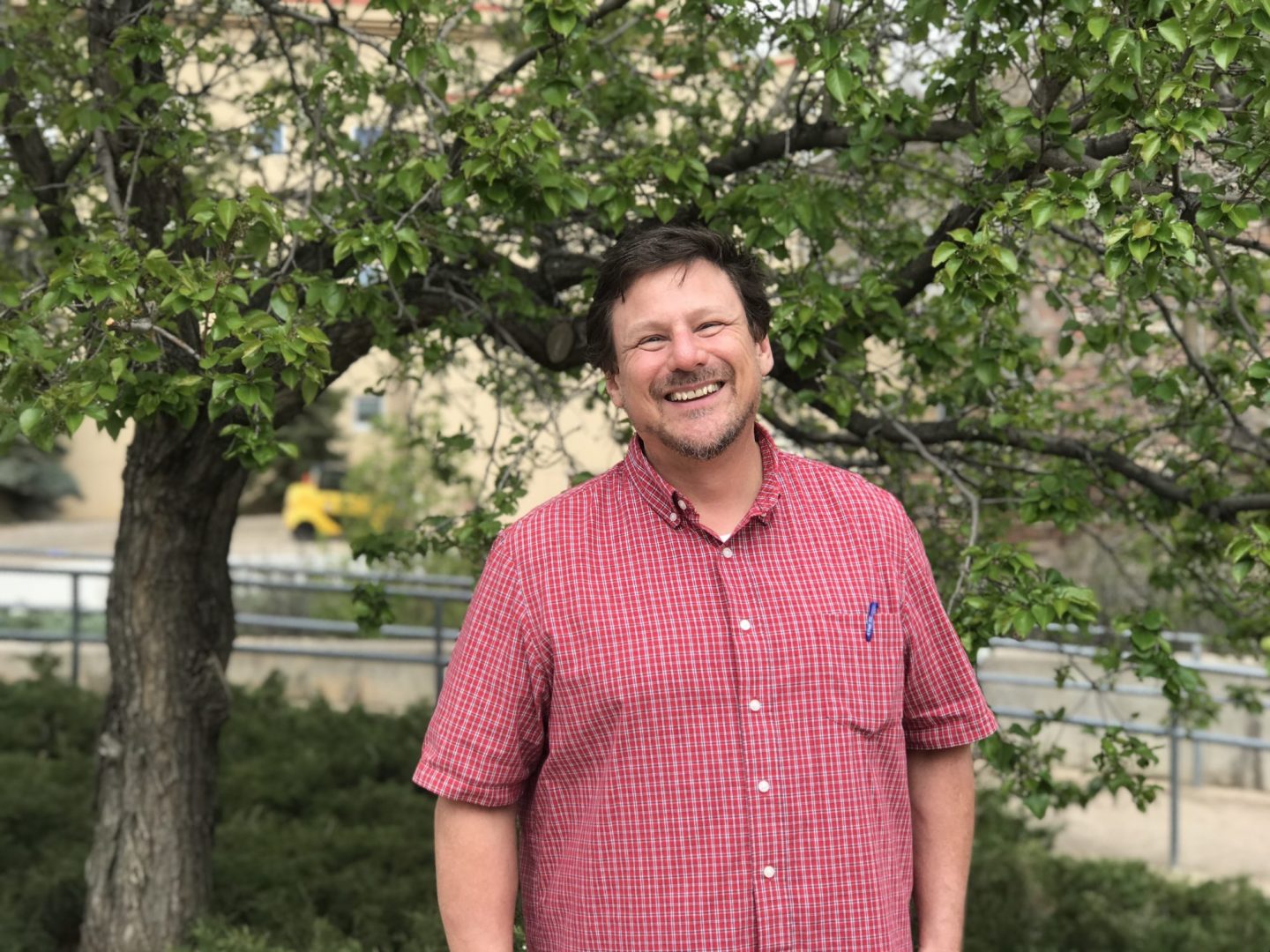 James Roller smiling under a tree on the CSU campus