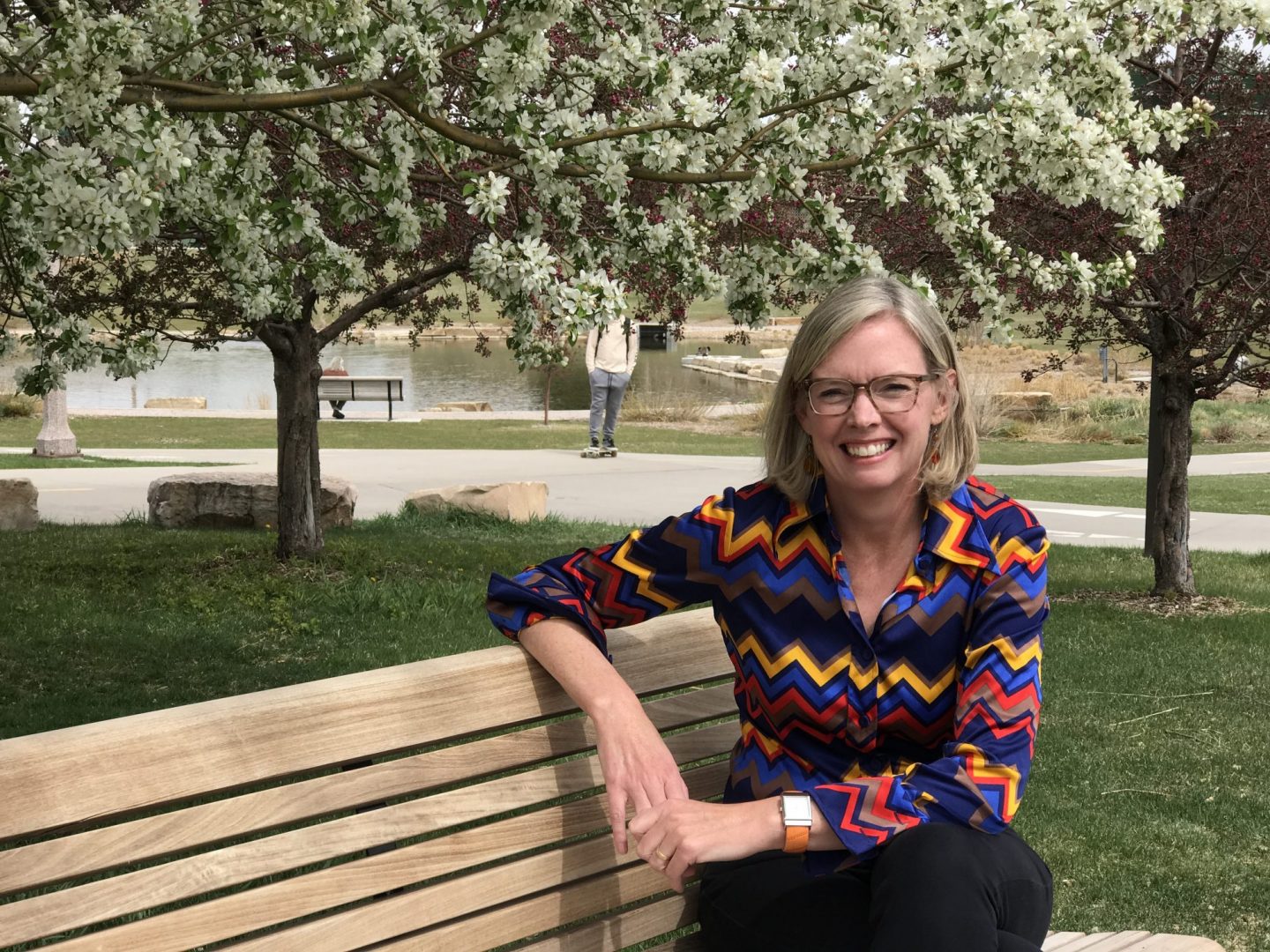 Kelly Bradbury sitting on an outdoor bench on a spring day on the CSU campus