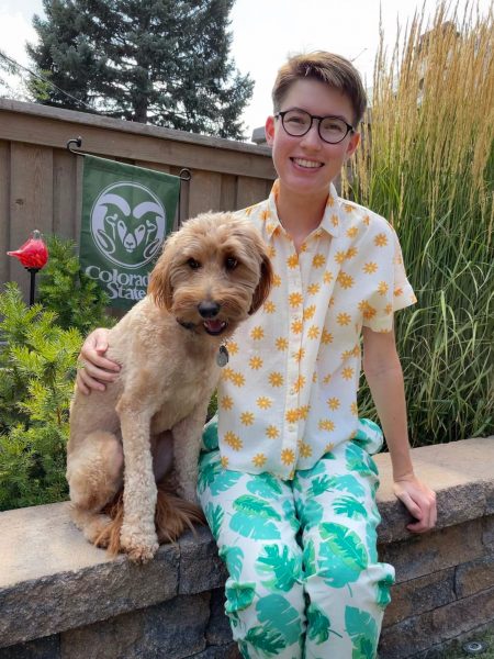 Photo of C.E. Janecek sitting outside on a bench with a dog.