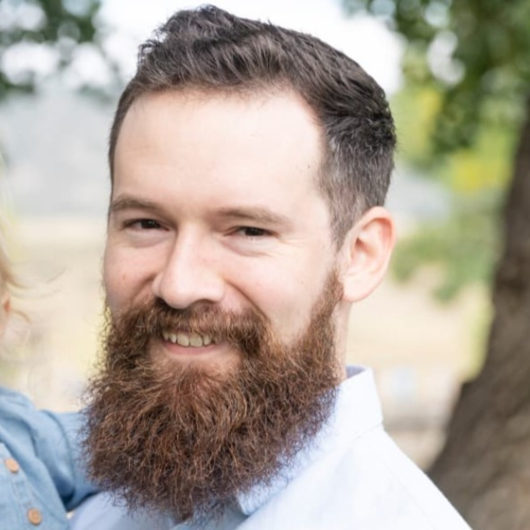 Ian Bagley headshot. Man has short brown hair and a prominent beard.
