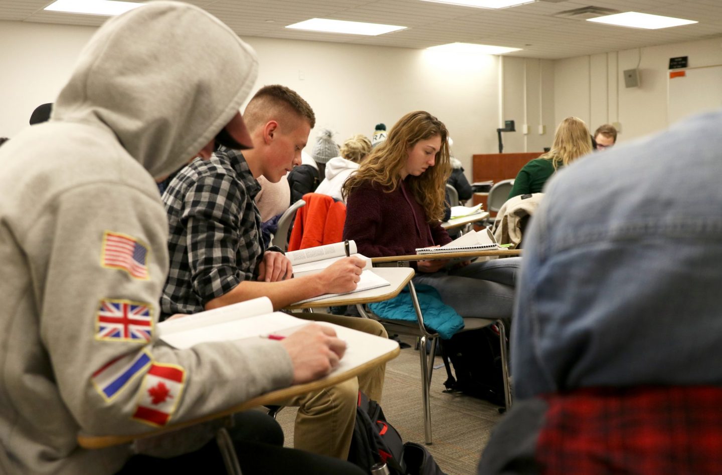 CSU students in classroom reading at desks.