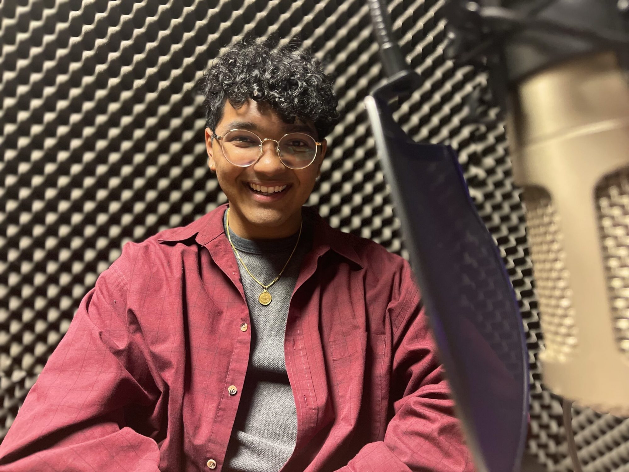 Ali Niaz sits in a podcast studio at Colorado State University, Feb. 6, 2024.