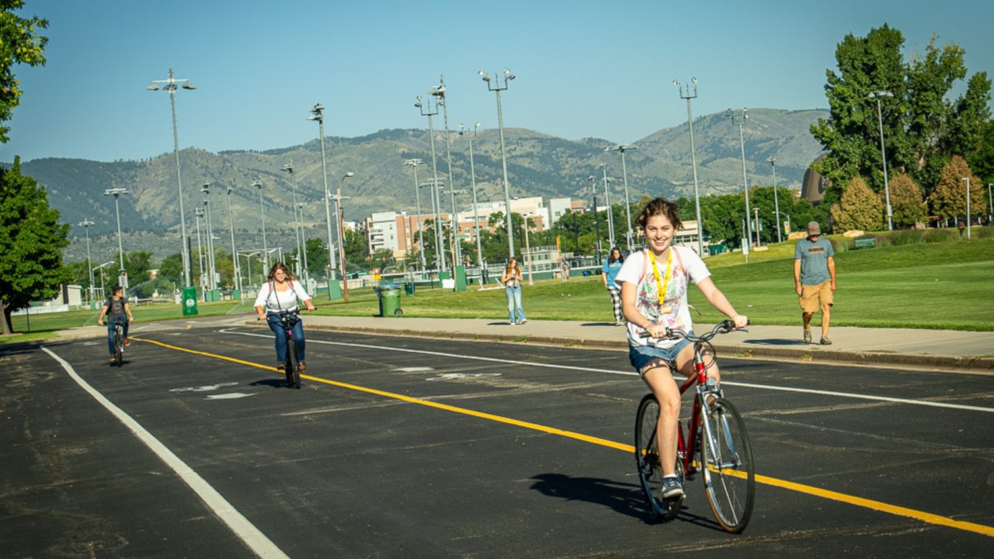 Student biking on CSU campus.