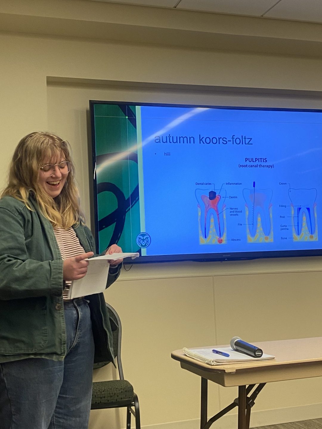 Autumn Koors-Foltz reads at the front of a classroom during the EGSA Fall Salon.