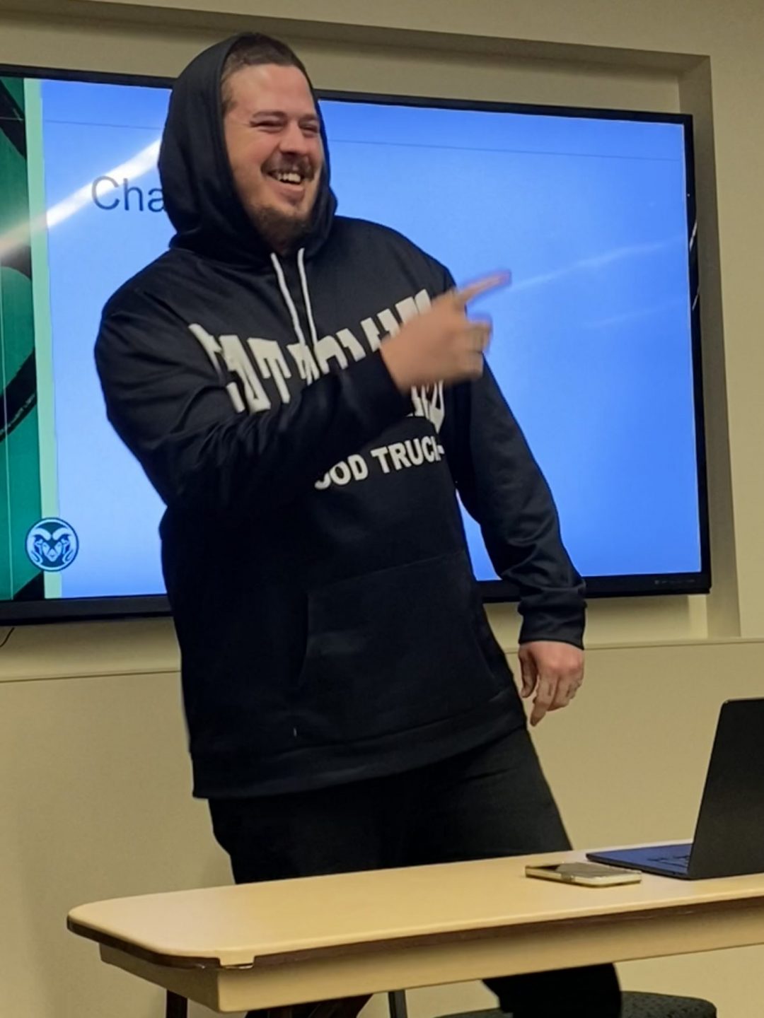 Chase Cate stands at the front of a classroom during the EGSA Fall Salon.