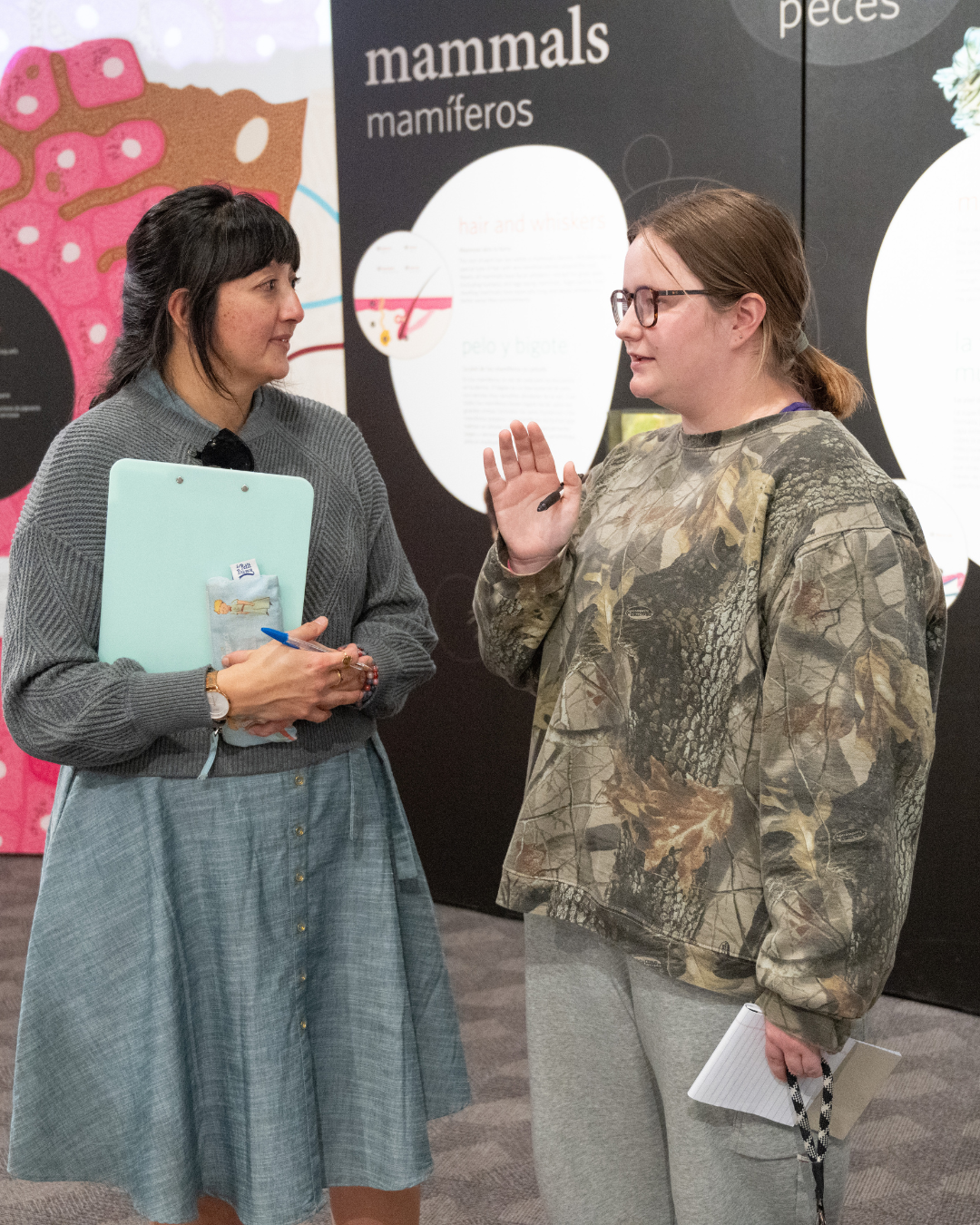 Professor and student in conversation during a field trip to a local museum.