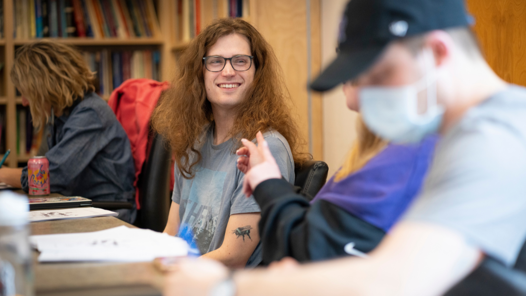 MFA student smiles during writing workshop, March 2026.