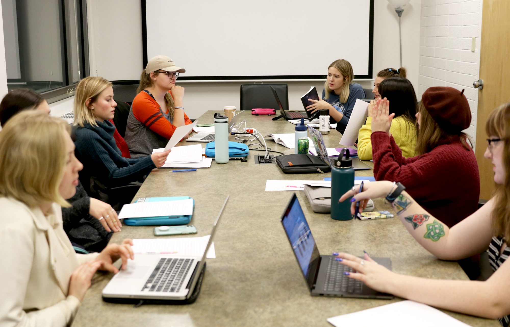 Greyrock Review interns collaborate on literary journal in classroom.