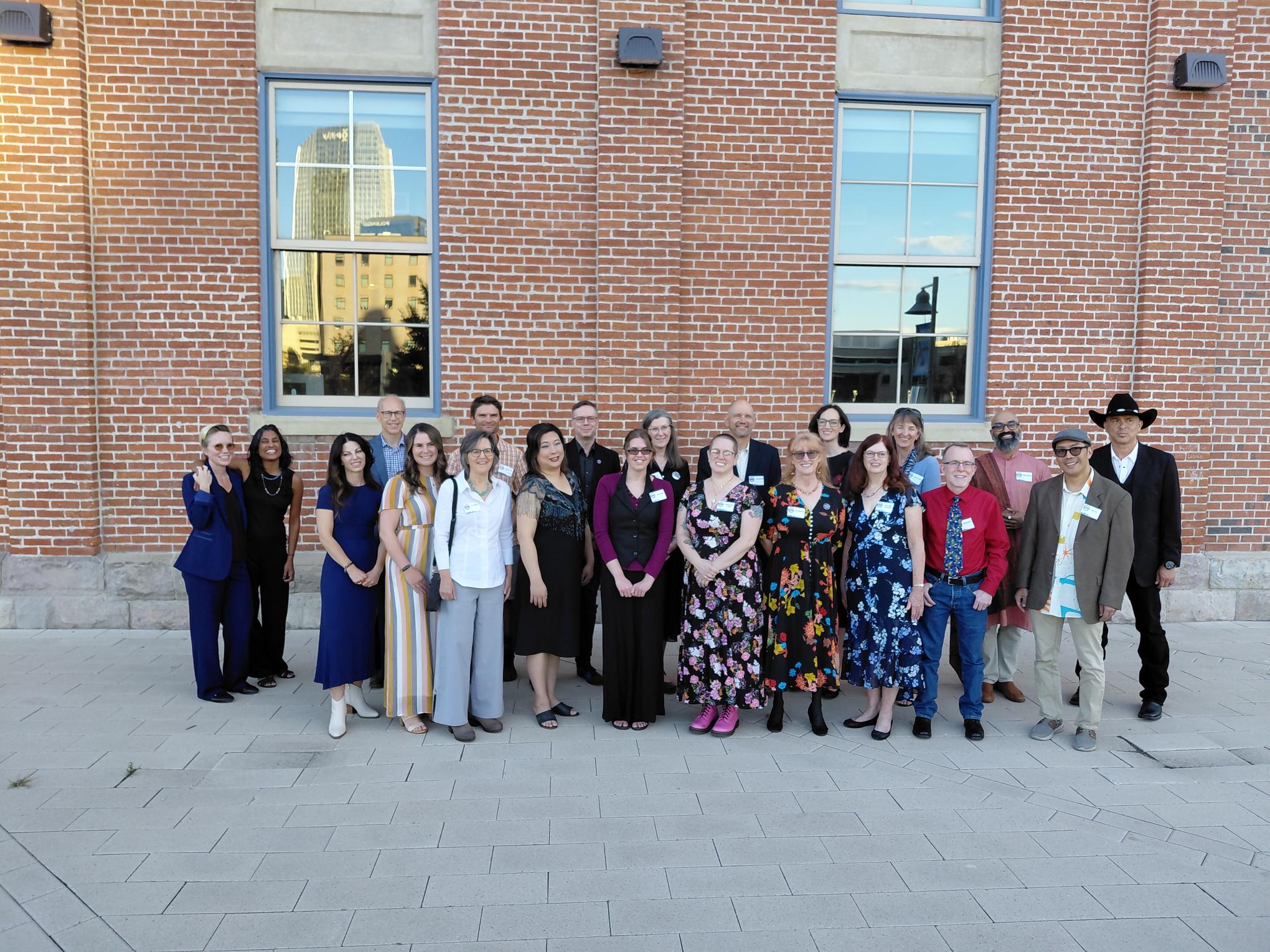 Finalists pose together outdoors in front of a brick building for the 2026 Colorado Book Awards.