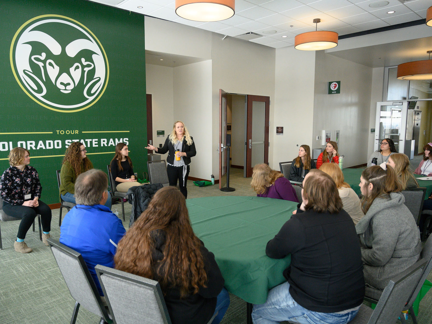 Presenter addresses room of attendees